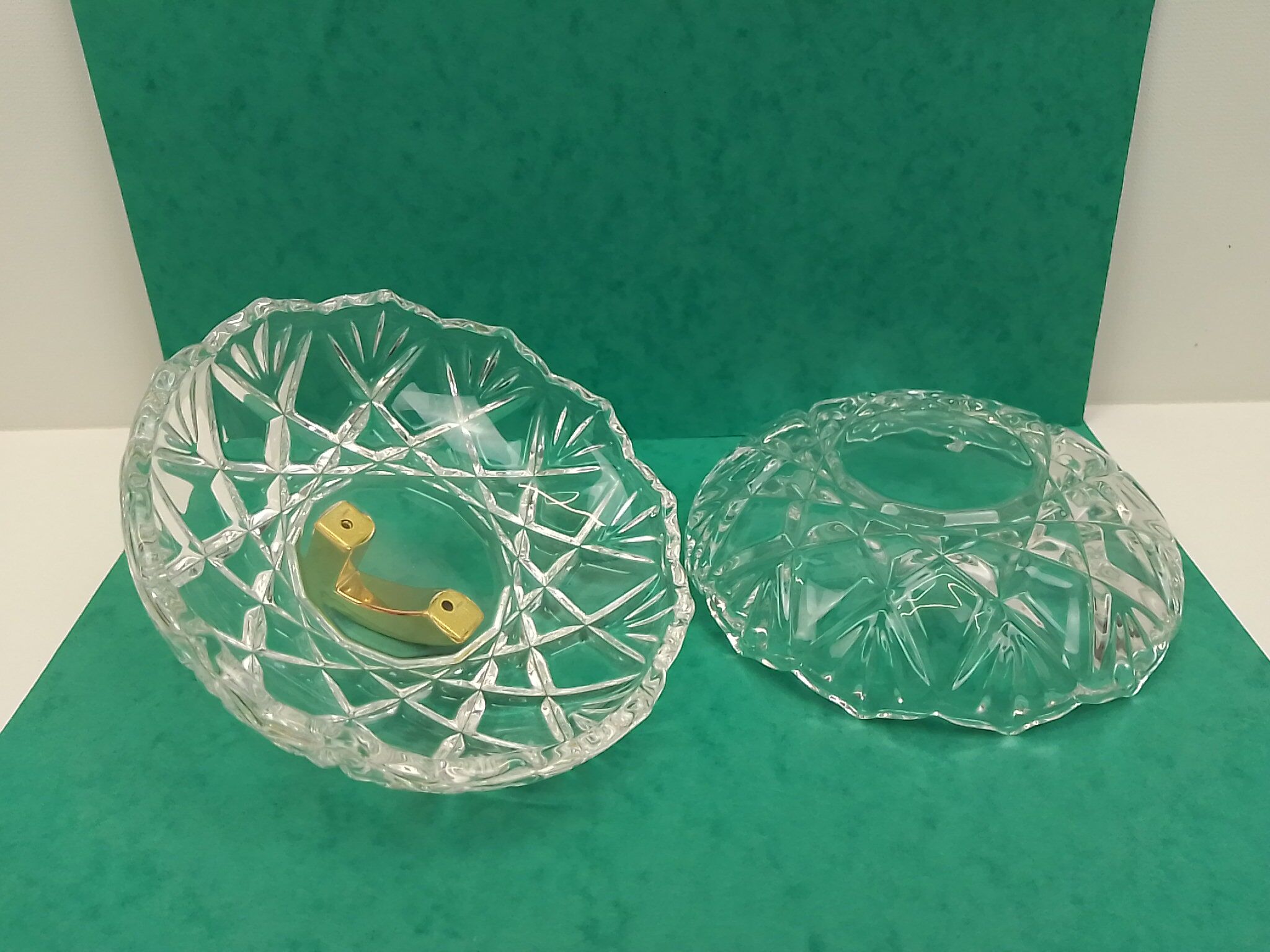 Round crystal box and a golden metal handle