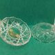 Round crystal box and a golden metal handle