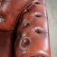 Cowhide chesterfield armchair in a warm brown colour with decorative nails