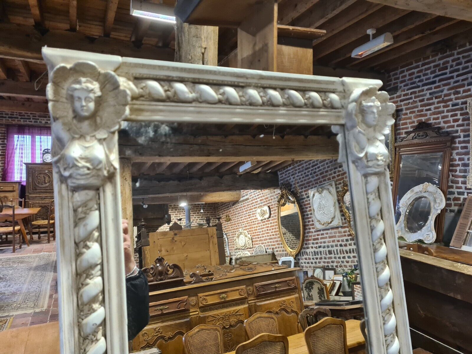 Beige patinated mirror with women's heads