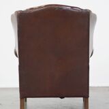 Comfortable, elegant, stately wing chair made of sheepskin in a beautiful warm color