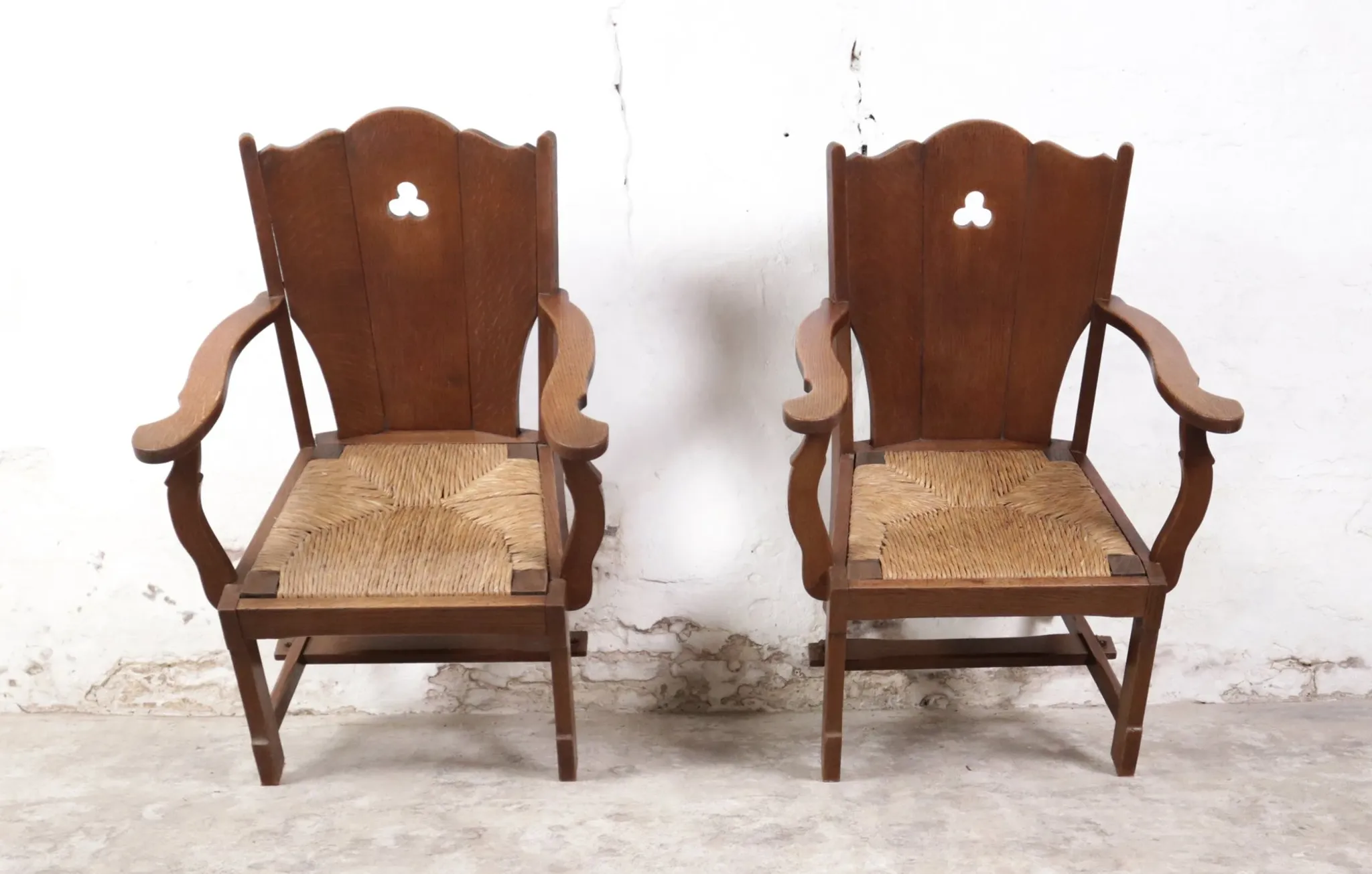 Pair of brutalist oak lounge chairs with rush seats – Netherlands