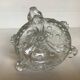 Thick moulded glass candlestick with fish and flowers.