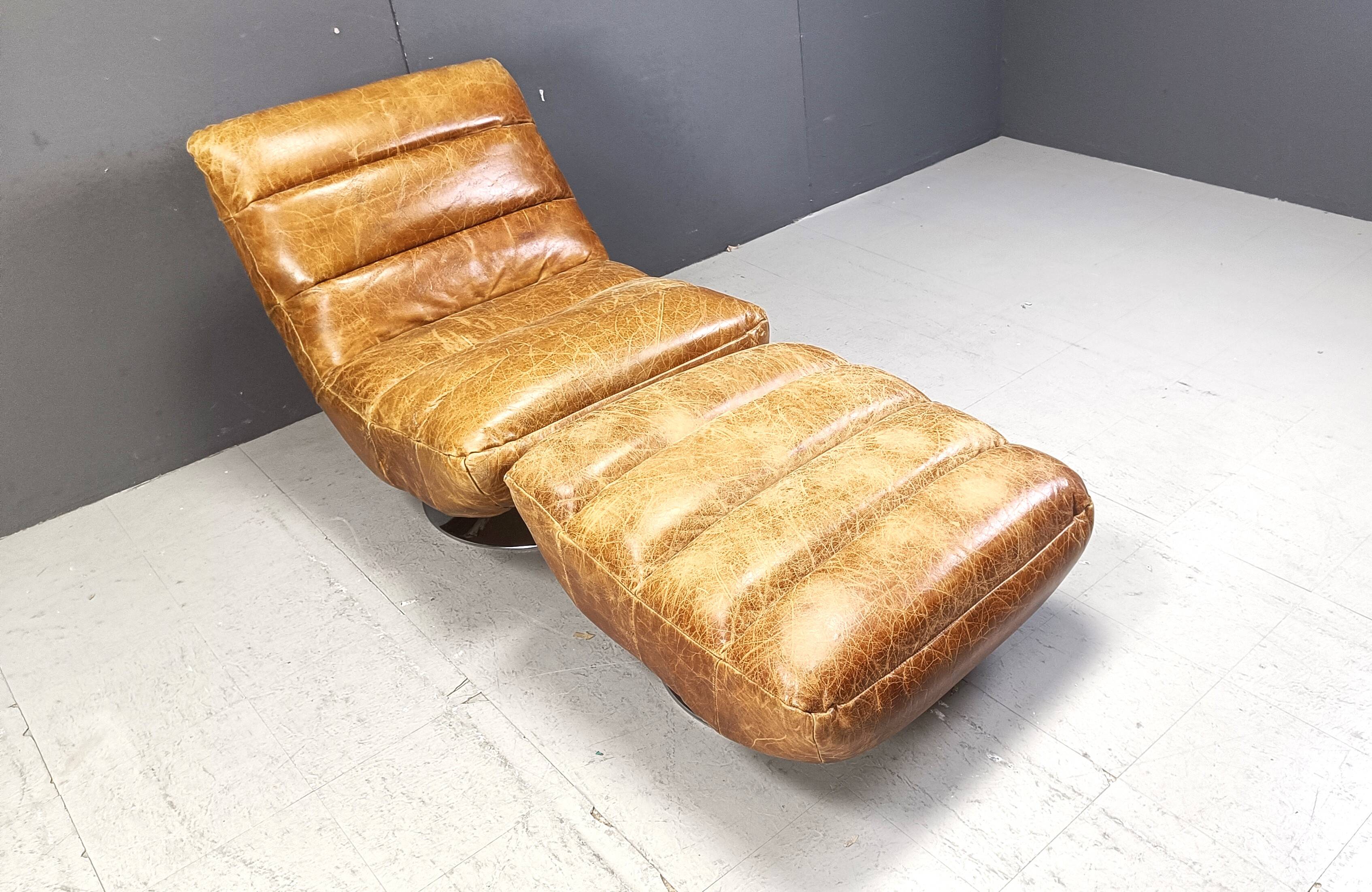 Vintage leather swivel chair with stool, 1970s
