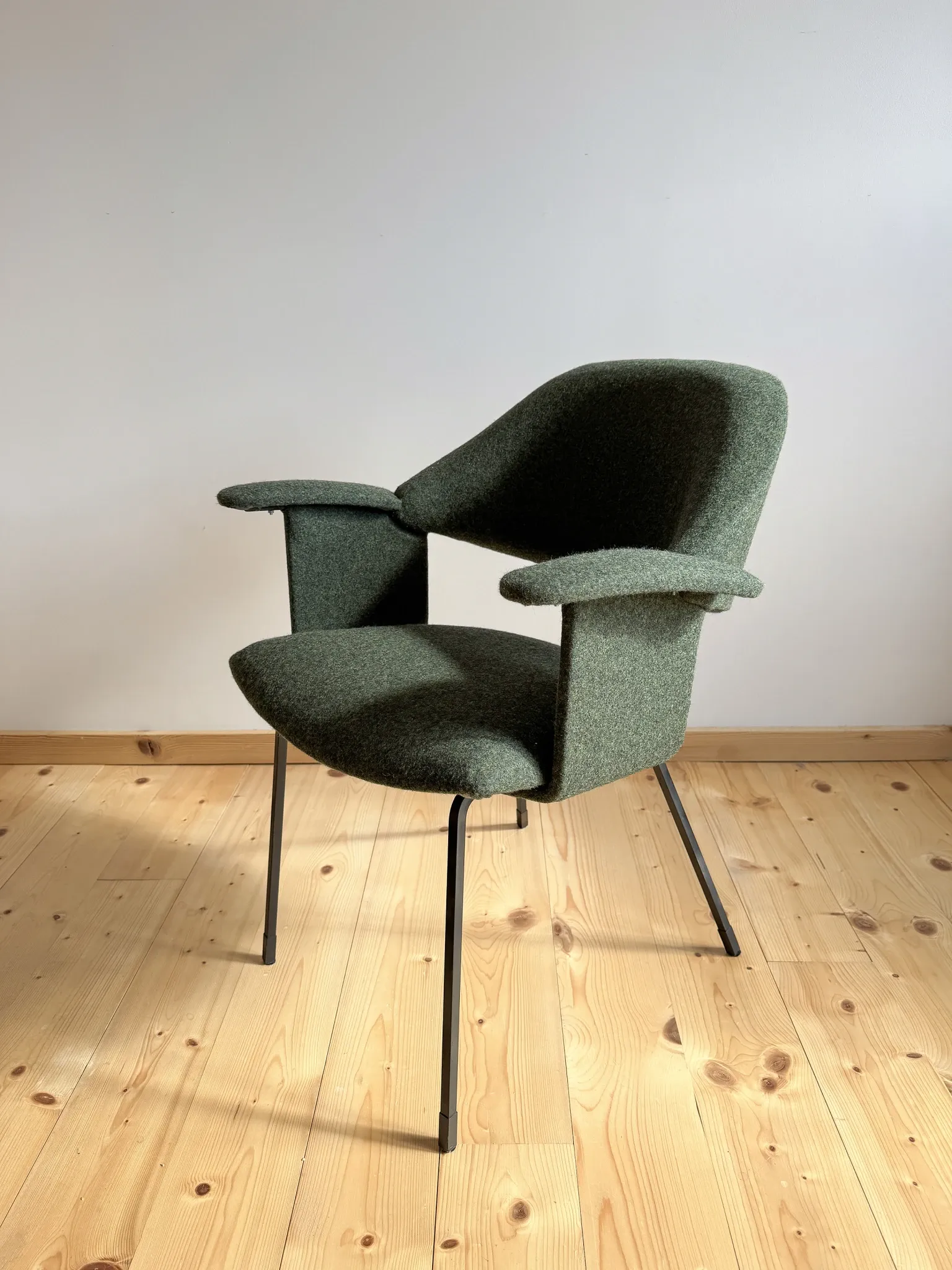 Curved vintage wool armchair from the 1960s