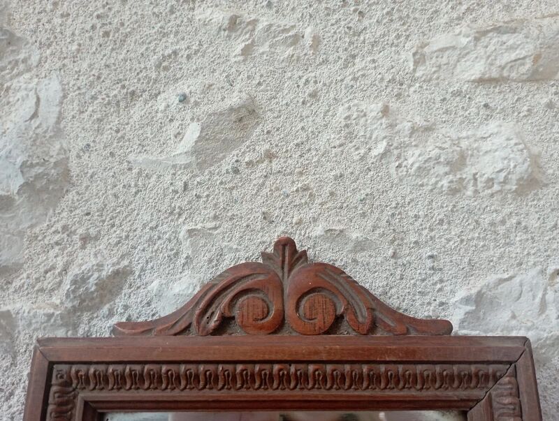 Set of two bevelled mirrors in moulded oak.