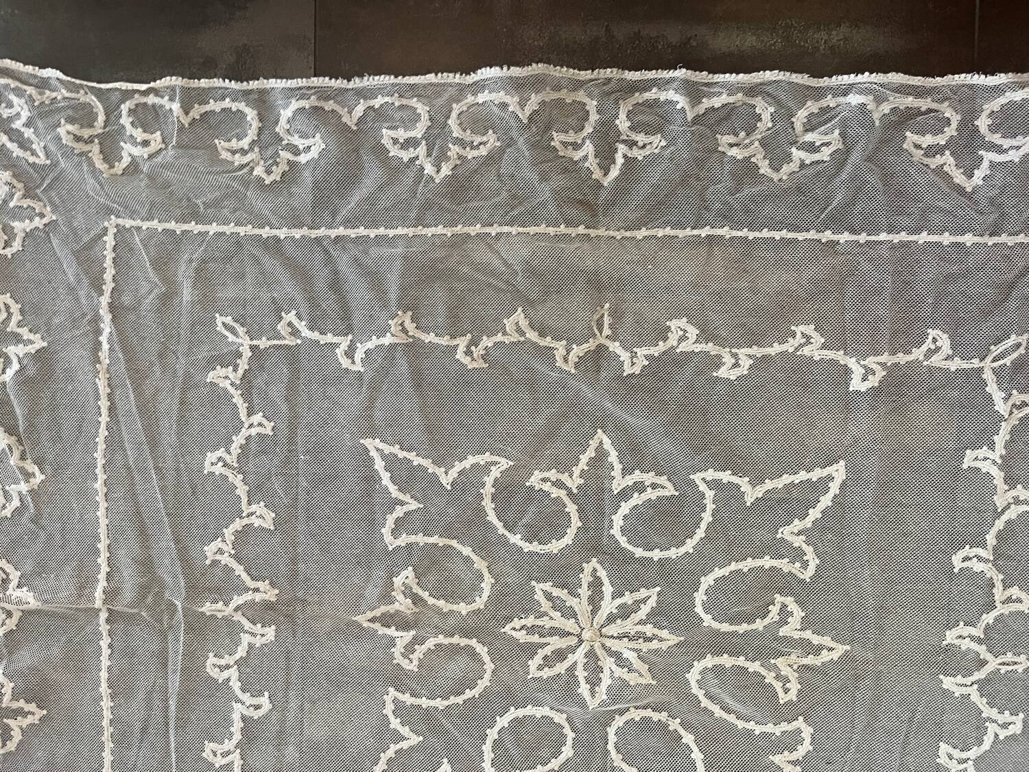 Old tablecloth embroidered with openwork embroidery.