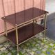 Brown rosewood rolling table with gold fluted legs