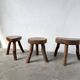 Set of three rustic solid wood tripod stools.