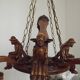 French vintage Breton chandelier with hand-carved figures, well, and lantern lights.