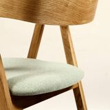 Vintage dining chair in light oak with natural linen pastel green fabric.