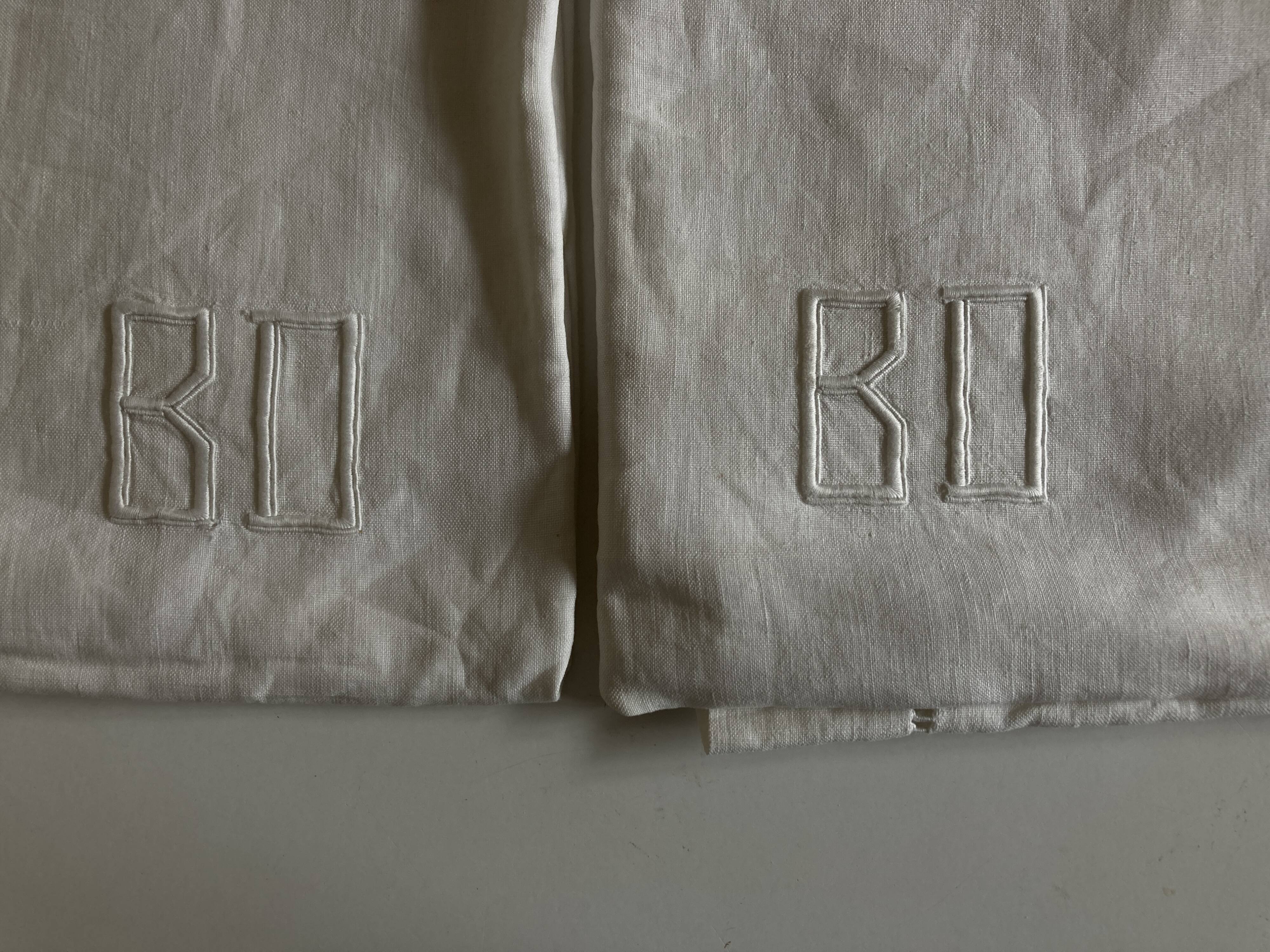 Pair of modernist linen pillowcases embroidered with comic strips