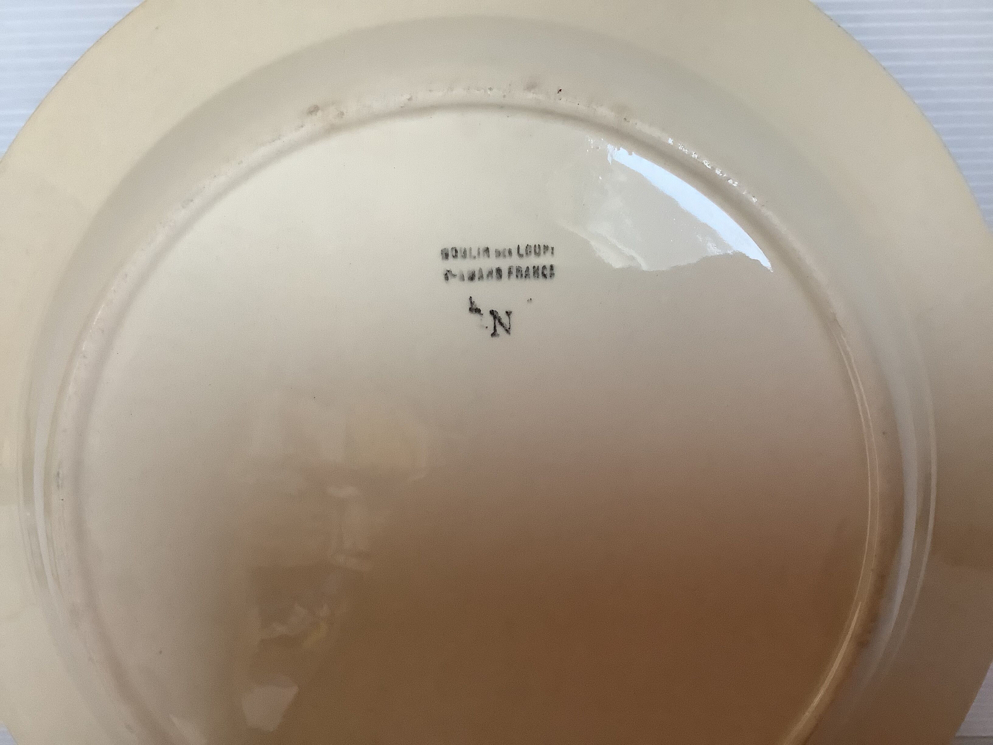 Earthenware plate from Moulin des Loups with stencil pattern.