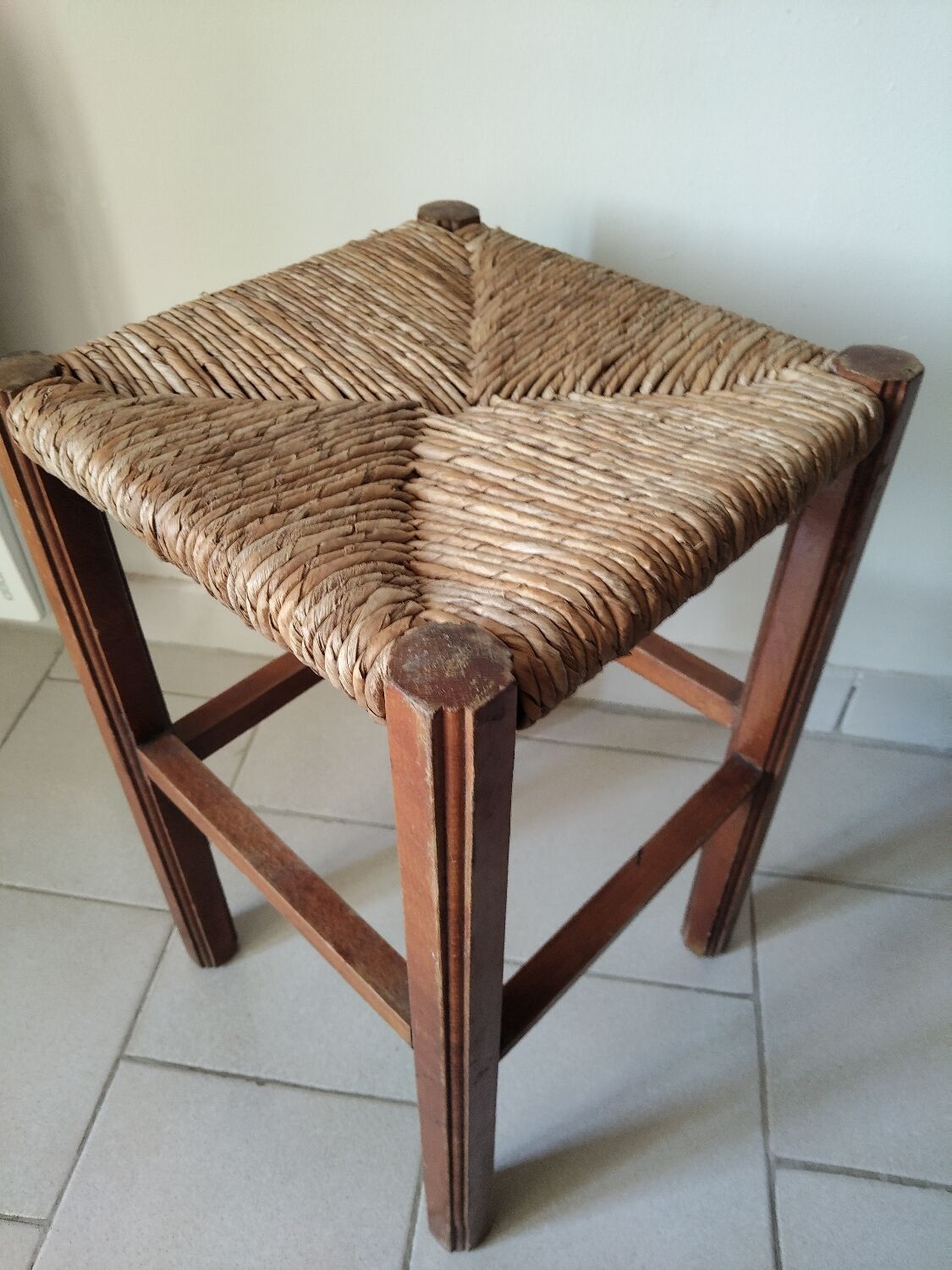 Antique campaign stool in solid wood with a straw seat.