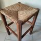 Antique campaign stool in solid wood with a straw seat.