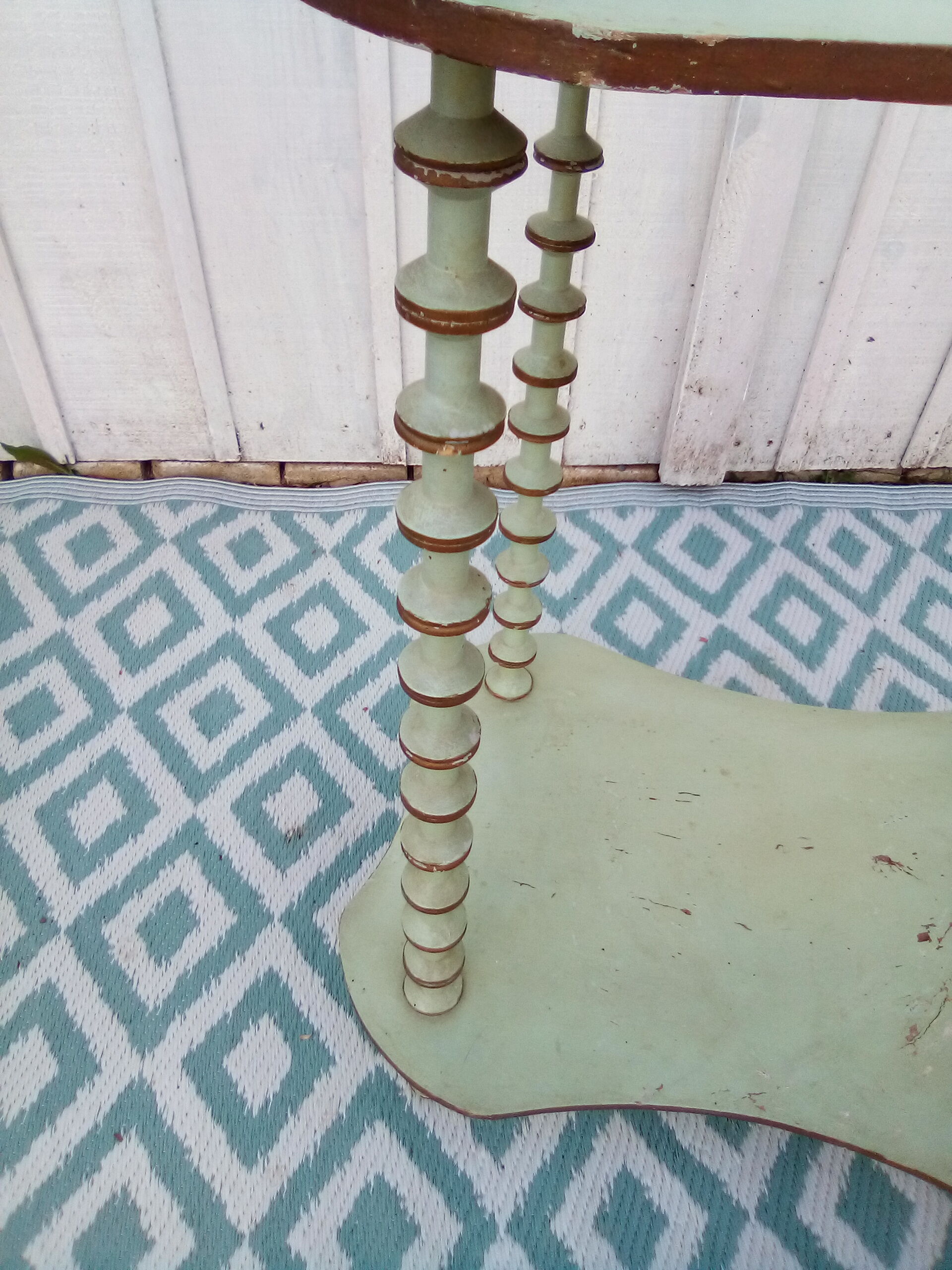 Shelf coils monogrammed patinated wood