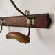 Old wooden and metal wall-mounted coat rack.