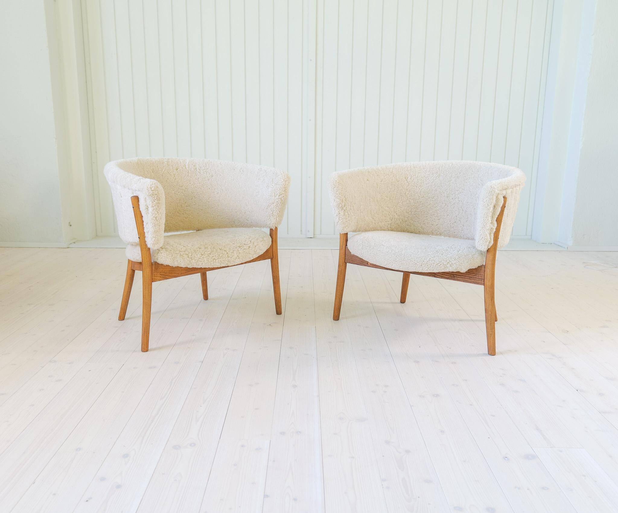 Mid-century lounge chairs in sheepskin/shearling and stained wood, Sweden, 1962.