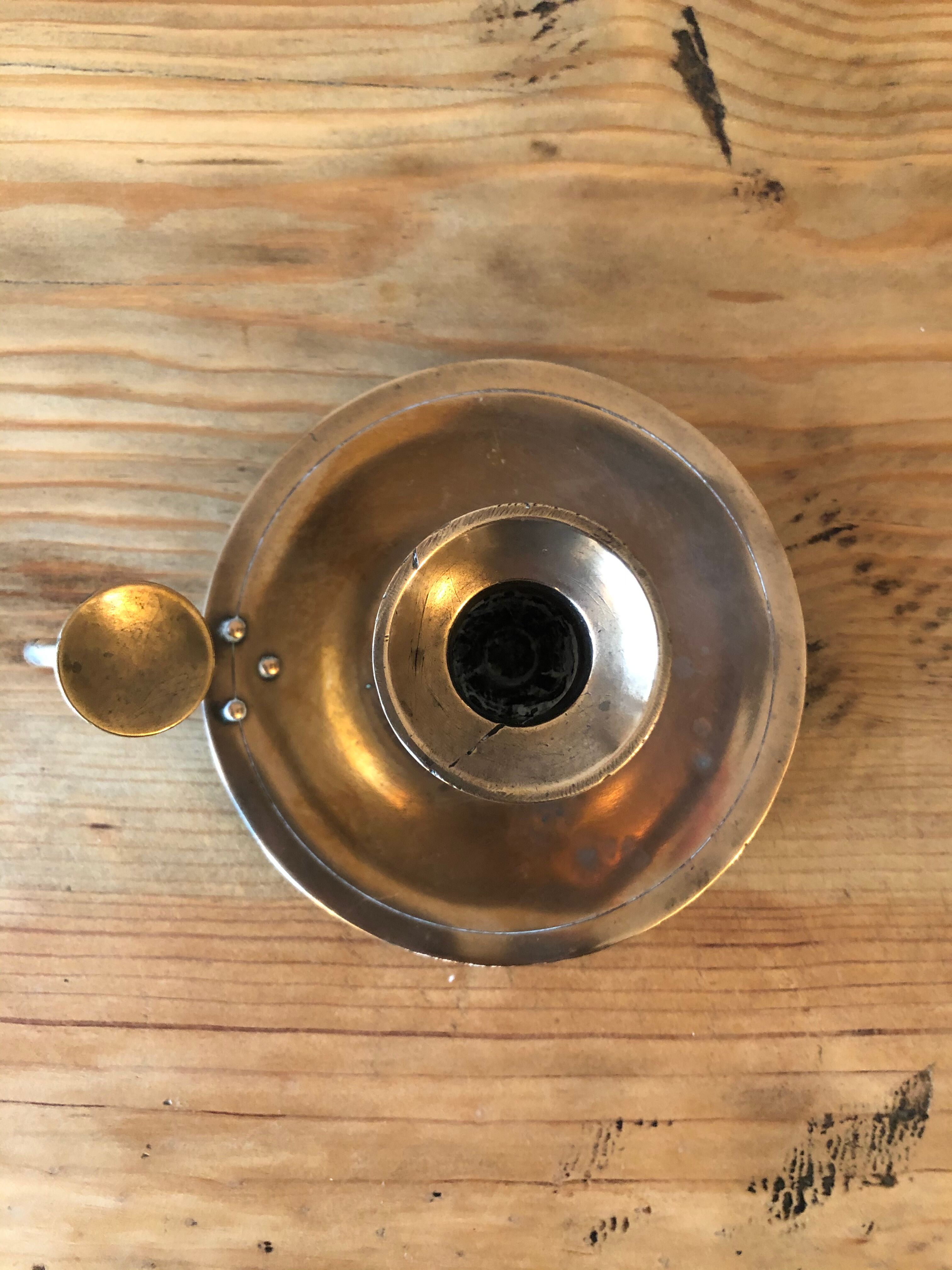 Old copper hand-held candlestick