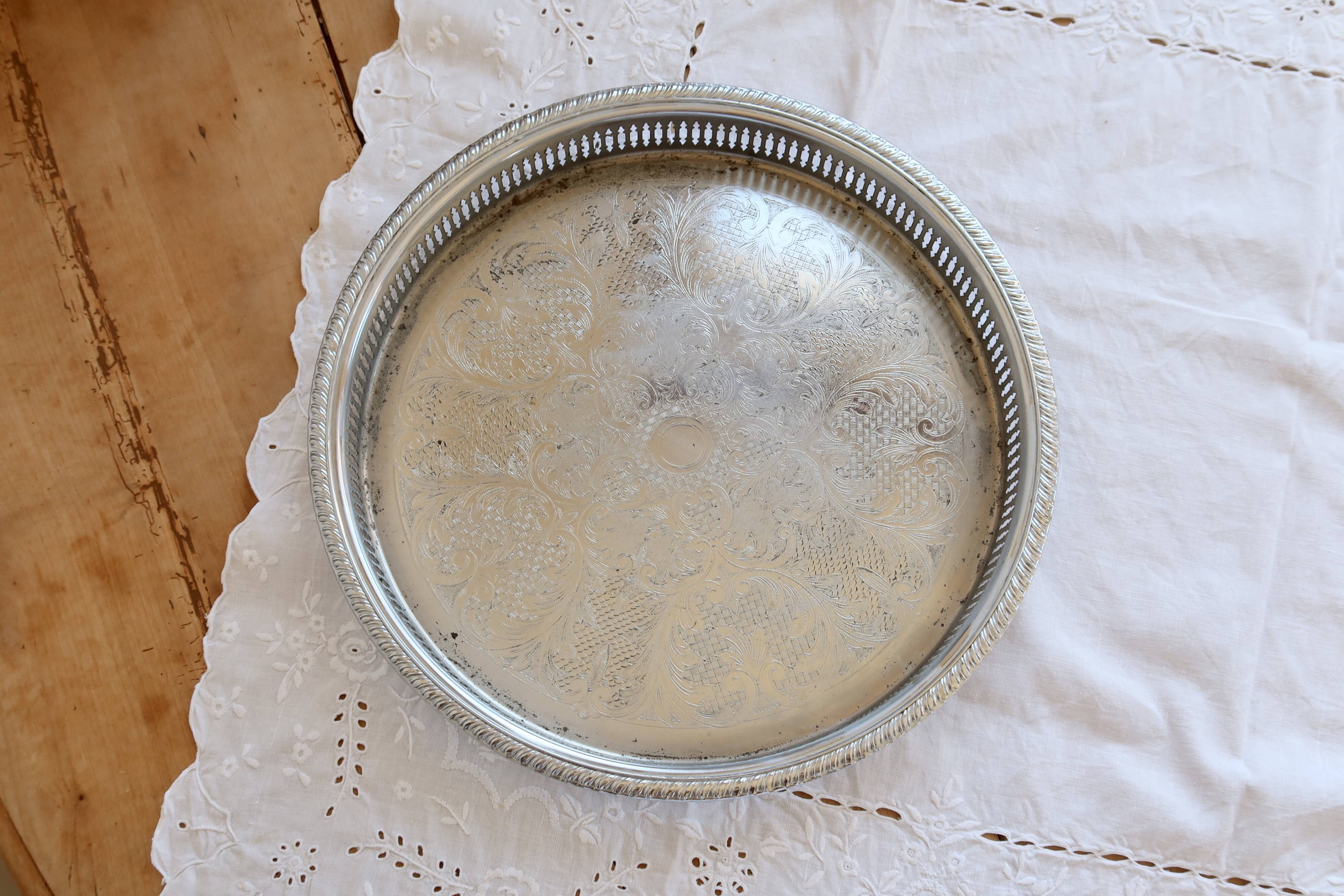 Large round vintage silver-plated metal tray, engraved and pierced.