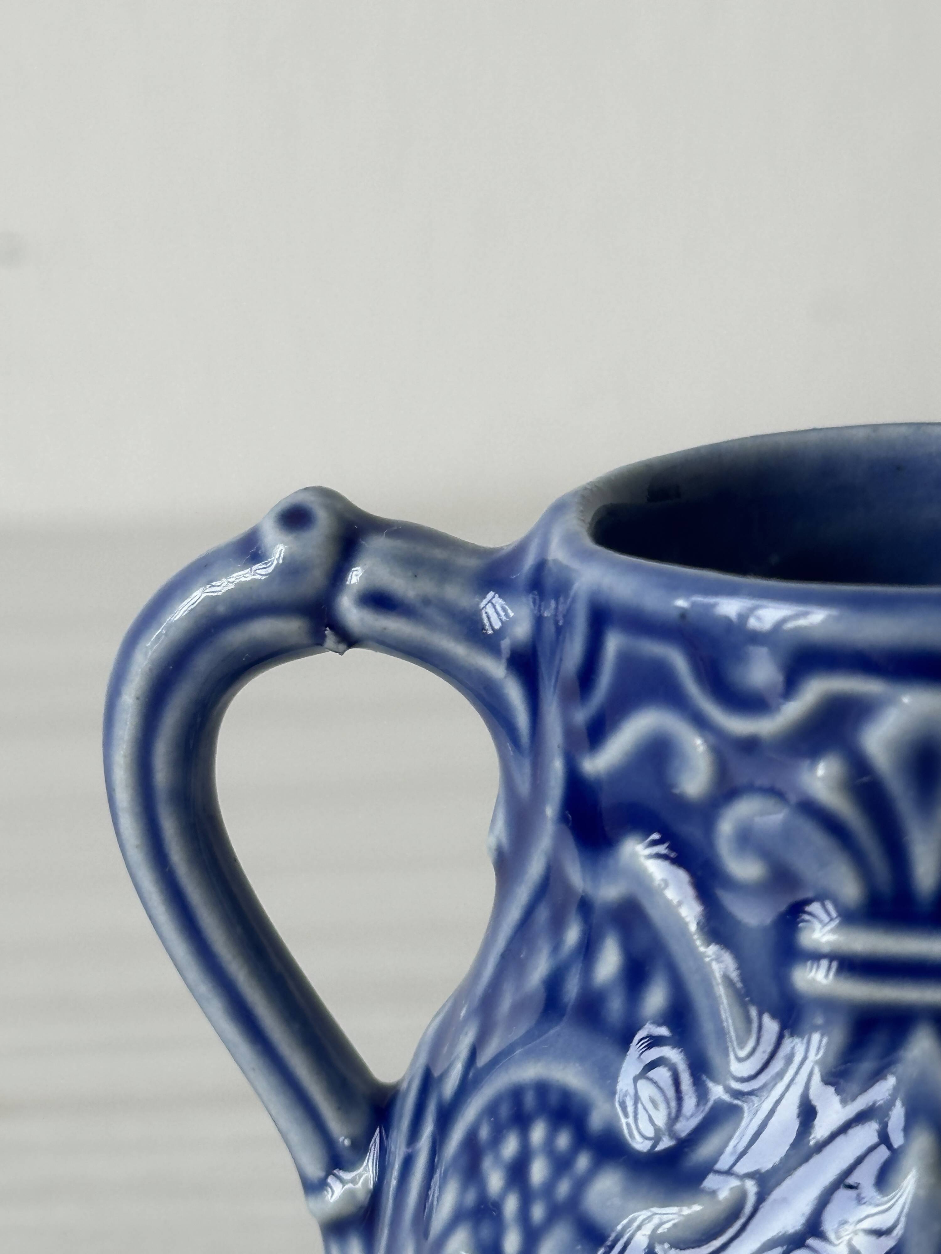 Old cream milk jug in slip