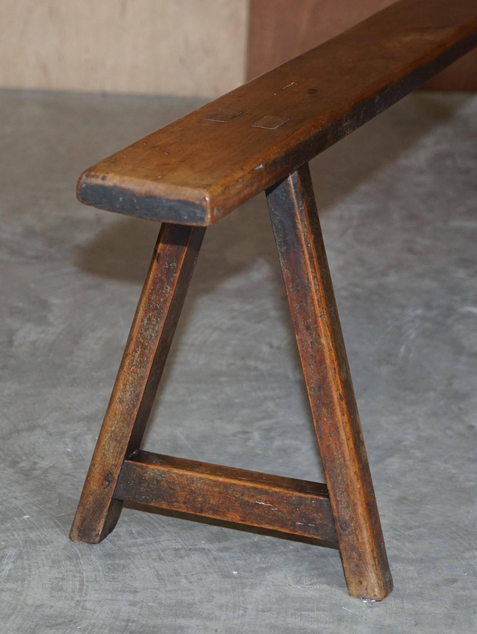 Pair of antique Victorian trestle benches in fruitwood.