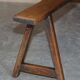 Pair of antique Victorian trestle benches in fruitwood.