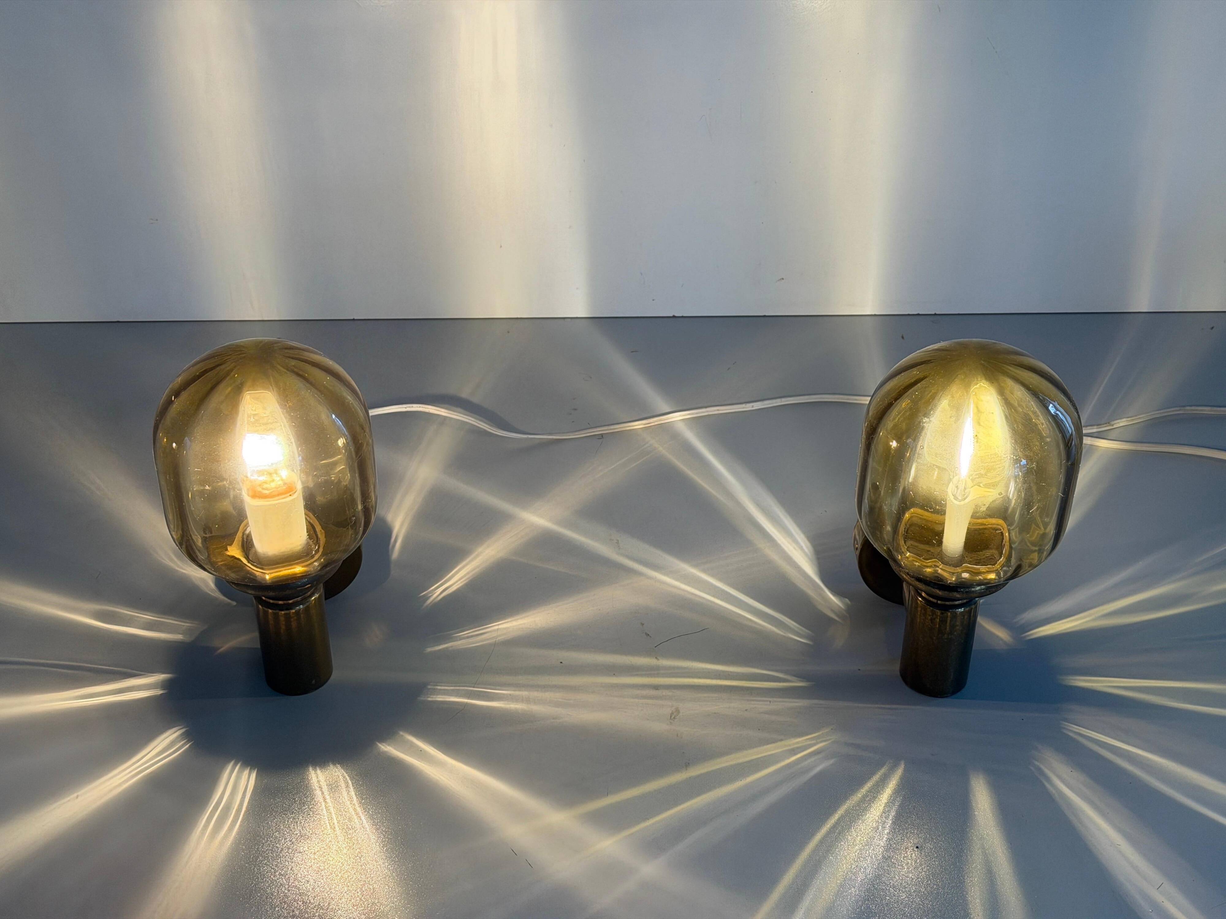 Pair of yellow glass and brass wall lights from the mid-century by N Leuchten, 1960s, Germany.