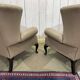 Pair of high-backed Chesterfield armchairs with 1 leather footrest