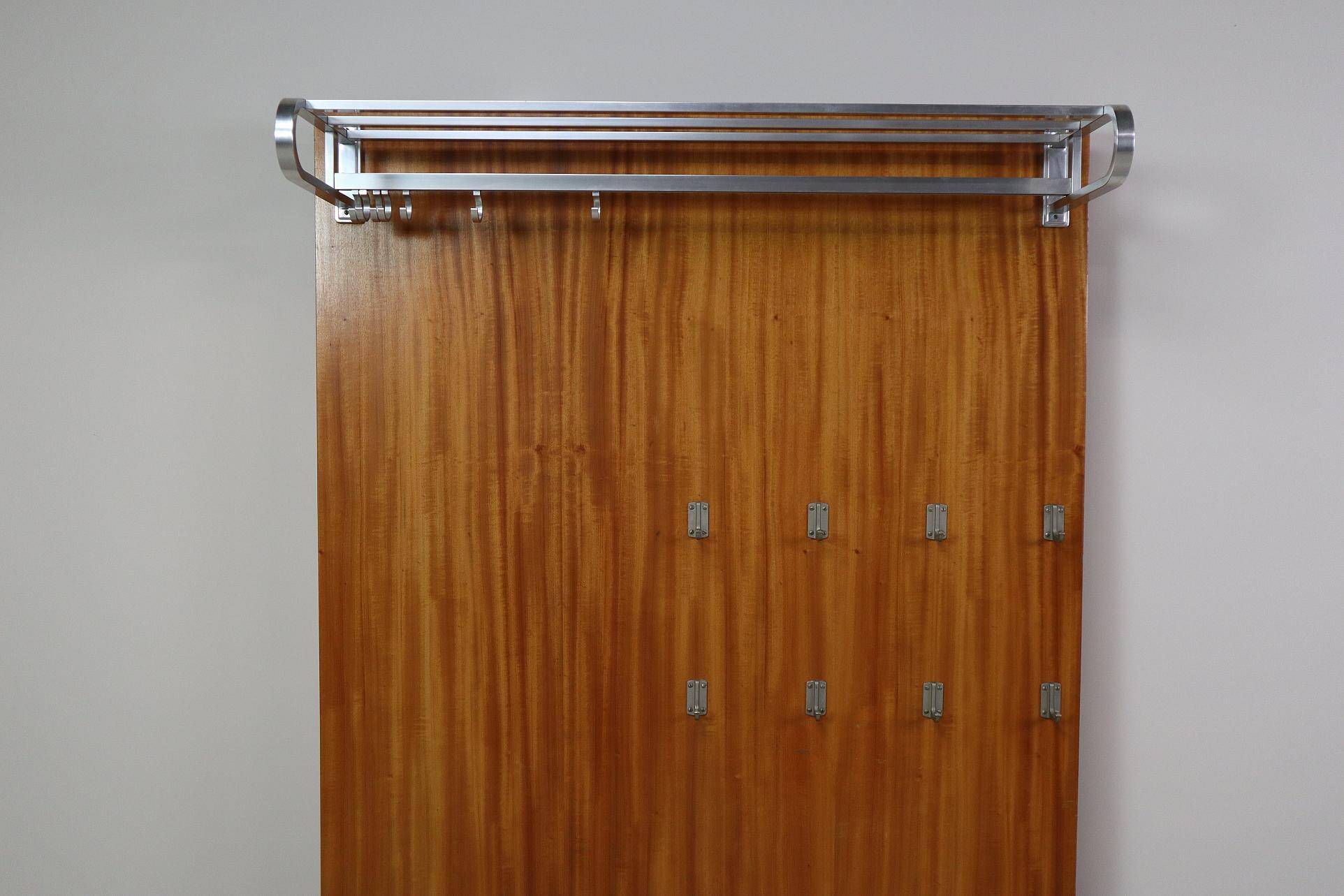 Modernist wall-mounted cloakroom in teak