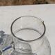 Vintage blown glass pitcher with bubbles, transparent.