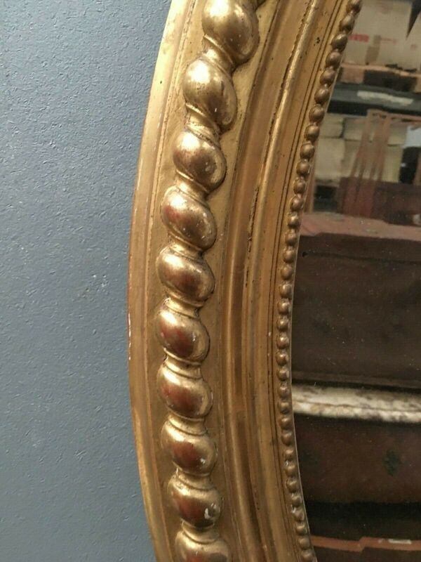 Miroir ovale a fronton en bois et stuc doré Glace ovale biseautée Napoléon III - 80x120cm
