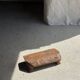 Small stool, footrest in blond teak, organic monoxyle with cut corners.