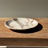 Tray, circular dish or plate made of white striped grey petrified wood.