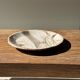 Tray, circular dish or plate made of white striped grey petrified wood.