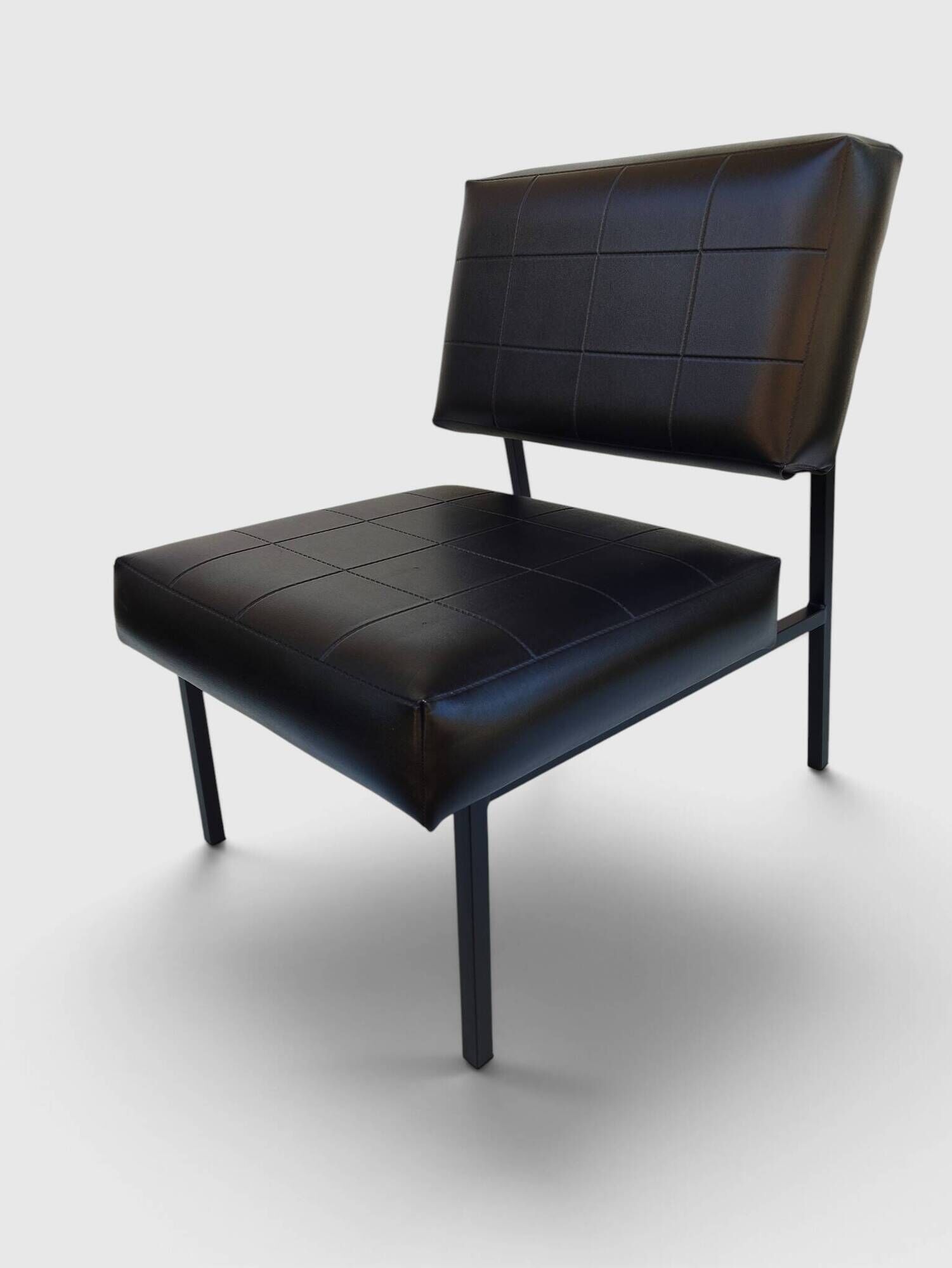 Modernist armchair in black faux leather and metal – 1960s