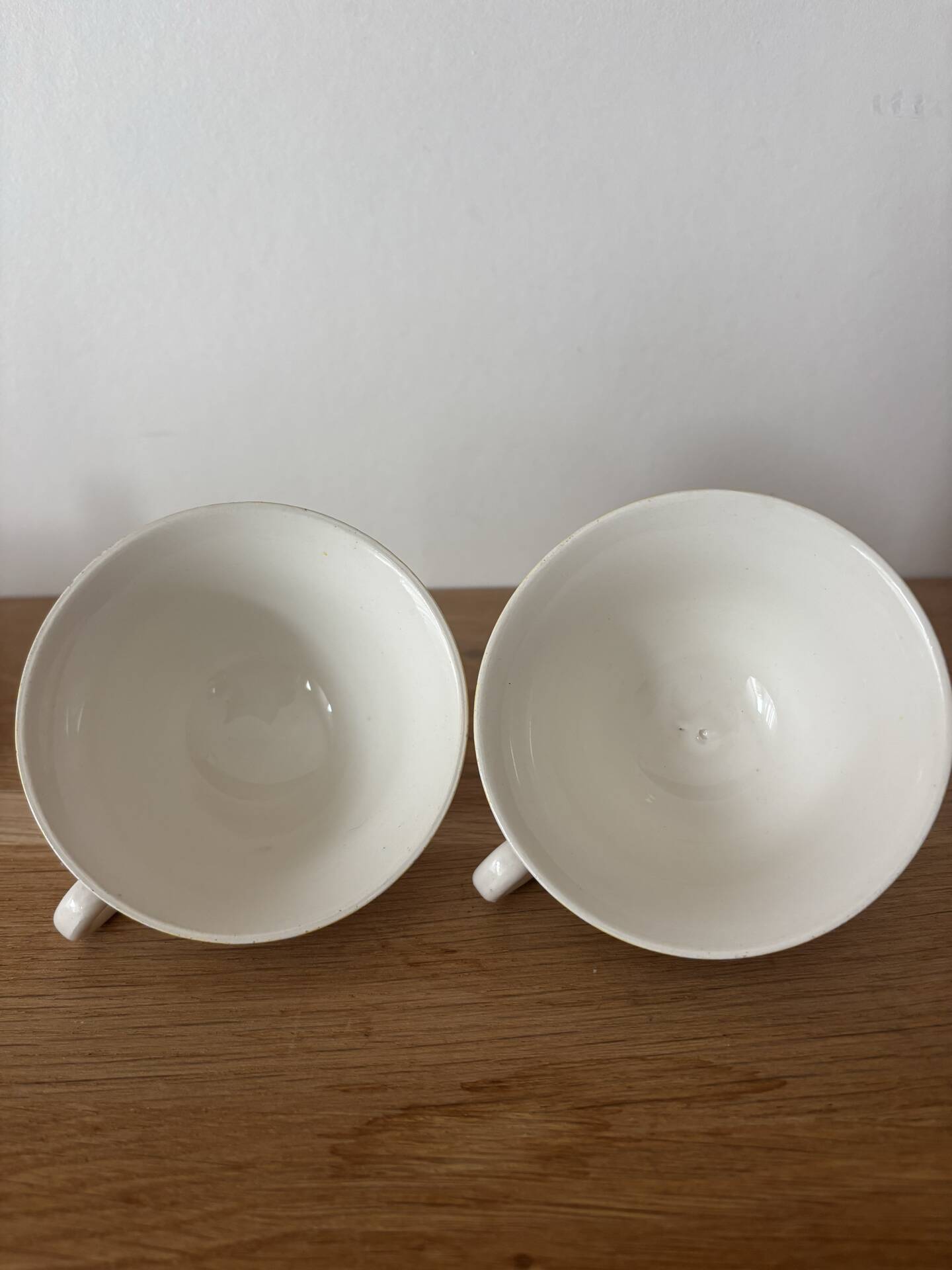 Set of two antique yellow Digoin Sarreguemines cups.
