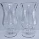 Pair of tall clear glass candlesticks from the early 20th century