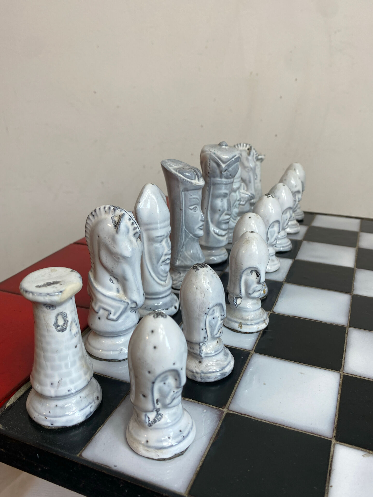 Chess set with ceramic board and pieces.
