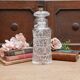 Large cut-glass carafe with a wide, flat, circular stopper