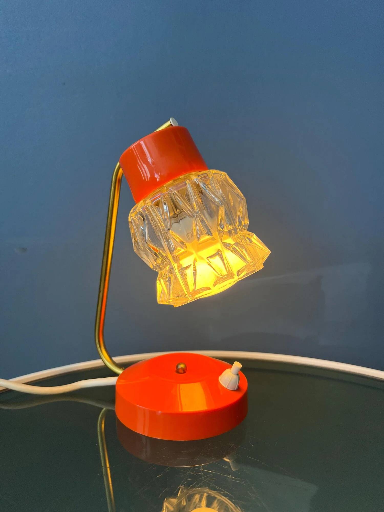 Small orange desk lamp with clear crystal glass shade