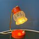 Small orange desk lamp with clear crystal glass shade