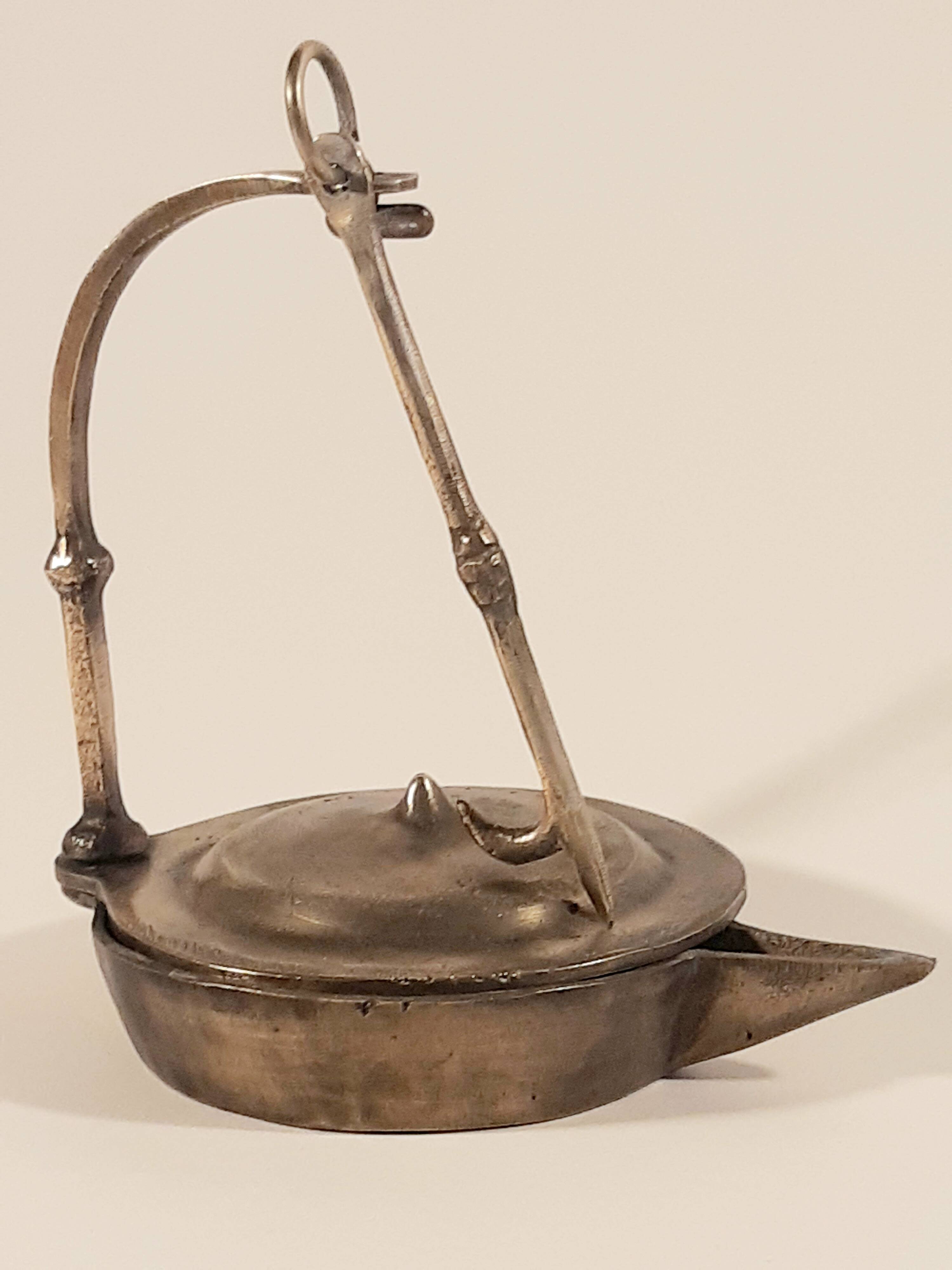 Old oil lamp in golden brass to hang