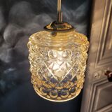 Moulded glass lamp with a cubic-spherical relief design.