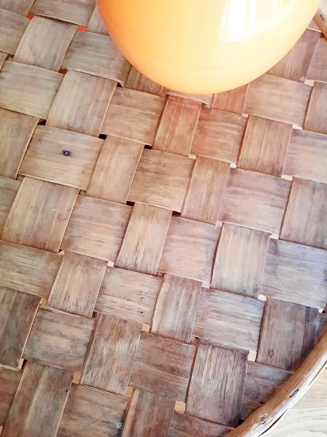 Old bamboo/rattan table with woven palm leaves.