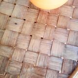 Old bamboo/rattan table with woven palm leaves.