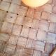 Old bamboo/rattan table with woven palm leaves.