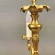 Older brass alloy chandelier with three light sources.