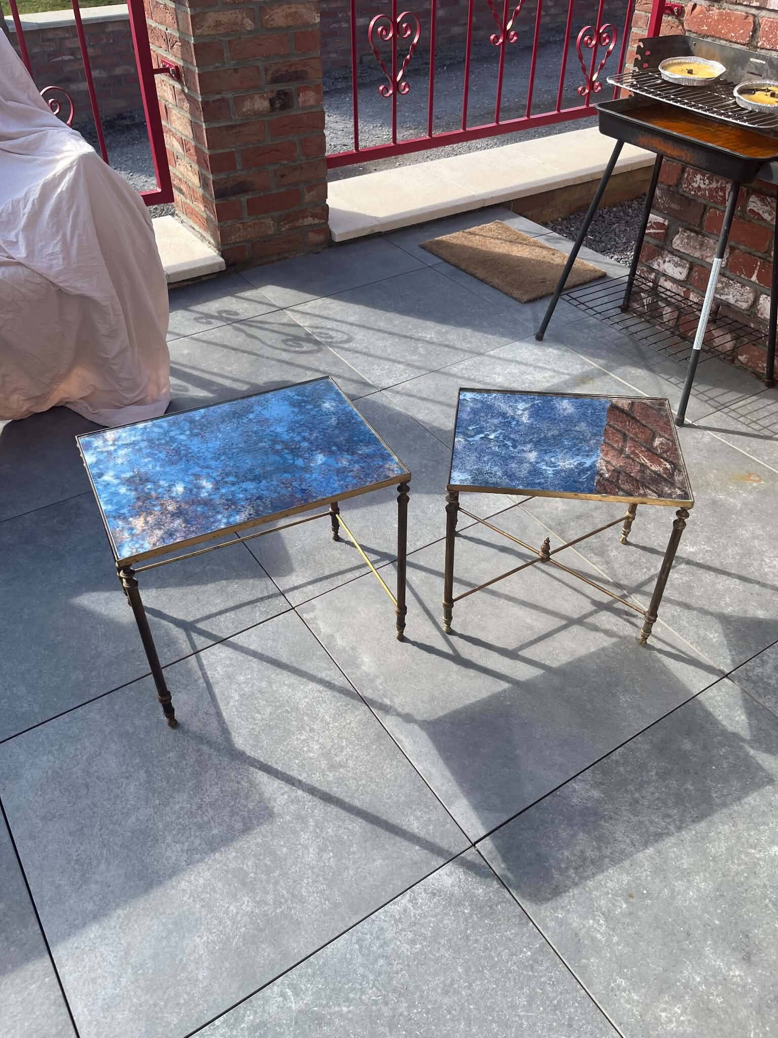 Pair of vintage nesting tables in gilded bronze and oxidised blue mirror, style