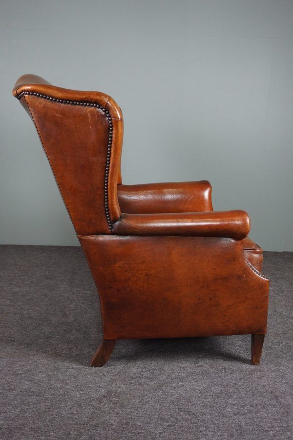 Eared armchair in patinated sheepskin